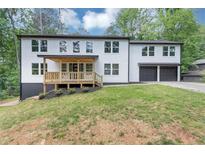 Bright, two-story home featuring a covered porch, two-car garage and clean, white facade at 212 Lake Forest Dr, Acworth, GA 30102