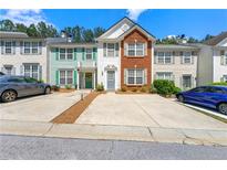 Charming townhome with a combination of brick and siding exterior and individual driveways at 4100 Howell Park Rd, Duluth, GA 30096
