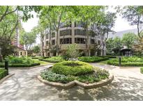 Beautifully landscaped grounds surround this mid-rise condo building with mature trees and manicured hedges at 3475 Oak Valley Ne Rd # 2060, Atlanta, GA 30326