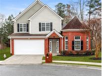 Charming two-story home with a brick facade and inviting front yard, plus an attached two-car garage at 3513 Newtons Crest Cir, Snellville, GA 30078