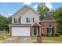 Charming two-story home with brick facade, a two-car garage, manicured lawn, and a welcoming entrance at 3513 Newtons Crest Cir, Snellville, GA 30078