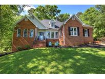 Charming brick home with a landscaped front yard and inviting entrance at 3695 Highway 140, Rydal, GA 30171