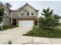 Two story home with two car garage and neutral siding, in need of yard maintenance at 2335 Hackamore Dr, Atlanta, GA 30349