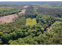 Expansive aerial view of lush, wooded land, creek, and a cleared area perfect for building at 2520 Hollonville, Brooks, GA 30205
