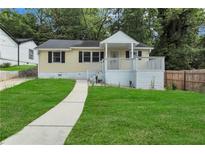 Charming home features a welcoming front porch and a well-manicured lawn at 2084 Bethel Nw Dr, Atlanta, GA 30314
