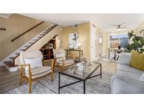 Bright living room featuring hardwood floors, staircase, modern furnishings, and an open floor plan at 136 Peachtree Memorial Nw Dr # Va2, Atlanta, GA 30309