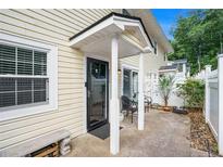 Cozy front entrance with a concrete patio, covered entrance, and neutral-colored siding at 2716 Suwanee Se Way, Marietta, GA 30067