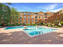 Beautiful community pool surrounded by lush landscaping and lounge chairs in a courtyard setting at 10 Perimeter Summit Ne Blvd # 3109, Atlanta, GA 30319