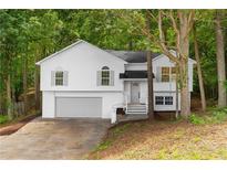 Charming two-story home with a two car garage nestled among mature trees at 223 Old Alabama Se Rd, Emerson, GA 30137
