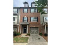 Charming brick townhome with black shutters, two-car garage, and well-maintained lawn in a desirable neighborhood at 1466 Dolcetto Nw Trce # 18, Kennesaw, GA 30152