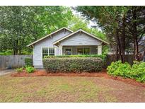 Charming bungalow featuring manicured landscaping and a welcoming front porch at 1761 Flat Shoals Se Rd, Atlanta, GA 30316
