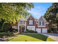 Beautiful two-story brick home featuring an attached two-car garage and a well-manicured lawn at 5004 Lake Mist Se Dr, Mableton, GA 30126