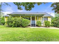 Charming single-story home with a welcoming front porch and lush green lawn at 4720 Bill Cheek Rd, Auburn, GA 30011