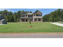 Beautiful two-story brick home with well-manicured lawn and a welcoming front entrance at 68 Homesite Cooper W Cv, Fayetteville, GA 30214