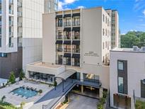 Beautiful condo building at 1421 Peachtree Street, featuring a fountain, covered entry, and secure parking at 1421 Peachtree Ne St # 214, Atlanta, GA 30309