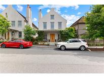 Charming two-story home with white exterior, manicured landscaping, and a welcoming front porch at 110 3Rd St, Fayetteville, GA 30214