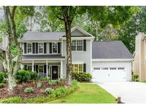 Charming two-story home with a well-manicured lawn and inviting curb appeal at 2759 Beddington Way, Suwanee, GA 30024