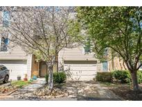Charming townhome with flowering tree, attached garage, and inviting entrance at 1127 Riverbend Club Se Dr, Atlanta, GA 30339