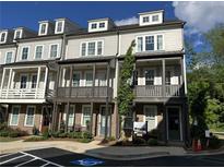 Exterior view of modern townhomes featuring individual balconies and covered front entries for stylish curb appeal at 4200 Legacy Ln # 22, Acworth, GA 30101