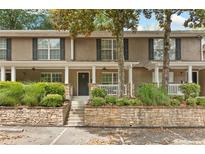Charming townhome with landscaped front yard, stone accents, and inviting covered entry at 3200 Seven Pines Ct # 103, Atlanta, GA 30339