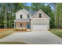 Charming two-story brick home with a well-manicured lawn and a welcoming blue front door at 3902 Bouldercrest Se Rd, Ellenwood, GA 30294
