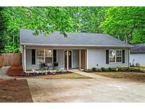 Charming single-story home with gray siding, black shutters, and a well-manicured front yard at 2565 Bates Se St, Smyrna, GA 30080