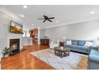Bright, open living room with hardwood floors, fireplace, and seamless flow to the kitchen at 2690 Derby Ne Walk # 53, Atlanta, GA 30319