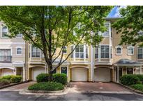 Inviting townhome exterior with attached garages and well-maintained landscaping offering curb appeal at 375 Highland Ne Ave # 913, Atlanta, GA 30312
