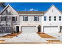 Charming townhomes with gray and white exteriors, garages, and well-maintained landscaping at 405 Carrera Ln, Acworth, GA 30102