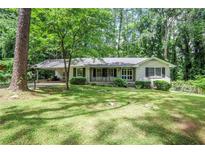 Charming brick home featuring a covered carport and a well-maintained, green front lawn at 1819 King Alfred Sw Dr, Atlanta, GA 30331