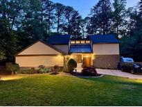 Charming two-story home with a well-maintained lawn and manicured landscaping at 4531 Kings Lake Dr, Marietta, GA 30067