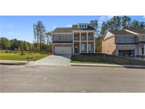 Charming two-story brick home with a two-car garage and a welcoming front porch at 101 Belvedere Rd, Mcdonough, GA 30253