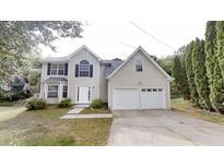 Charming two-story home with a double garage and well-maintained lawn at 5246 Salem Springs Pl, Lithonia, GA 30038