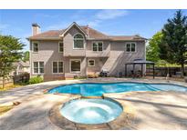 Beautiful in-ground pool and hot tub are ready for entertaining at 825 Yosemite Dr, Suwanee, GA 30024