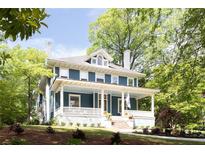 Charming two-story home featuring a welcoming front porch and a beautifully landscaped front yard at 118 Waverly Way, Atlanta, GA 30307