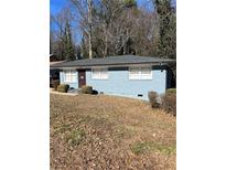 Charming one-story blue brick home with a well-maintained lawn and a cozy front entrance at 3385 Martin Luther King Jr Sw Dr, Atlanta, GA 30331