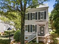 Charming two-story home features a welcoming entrance, classic shutters, and beautiful architectural details at 3848 Saint Annes Ct, Duluth, GA 30096