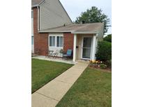 Inviting front porch with chairs, table, and vibrant flower accents at 636 North Ave # H-10, Jonesboro, GA 30236