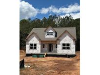 New construction home with a modern roof and windows ready for finishing touches and landscaping at 70 Oxford Rd, Oxford, GA 30054