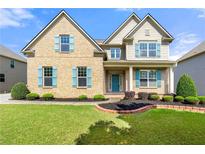 Charming two-story brick home with a well-manicured lawn and inviting curb appeal at 325 Cranbrooke Cir, Suwanee, GA 30024