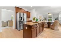 Modern kitchen featuring a center island with granite countertops and stainless steel appliances at 325 Cranbrooke Cir, Suwanee, GA 30024