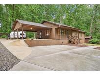 Charming single-Gathering home with a covered carport and inviting front porch at 5259 Sugar Ridge Dr, Sugar Hill, GA 30518