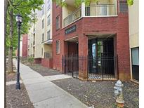 Brick building with the name 'The Washington' in front of entrance with a black metal fence and lamp post on the sidewalk at 870 Mayson Turner Nw Rd # 1447, Atlanta, GA 30314
