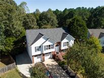 Charming two-story home with a well-manicured lawn, attached garage, and inviting front porch at 3265 Bethesda Park Ct, Lawrenceville, GA 30044