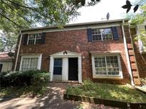 Brick townhouse with a traditional facade and a small front yard, offering a classic and inviting curb appeal at 2572 Stratford Ln, Morrow, GA 30260
