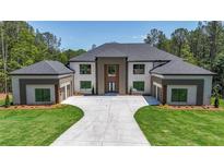 Stunning two-story home featuring a symmetrical design and large front yard with a long private driveway at 2843 N North Bogan Rd, Buford, GA 30519