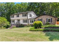 Charming two-story home with a combination of siding and brick exterior, and a beautifully landscaped front yard at 3441 Sherrod Sw Dr, Marietta, GA 30060