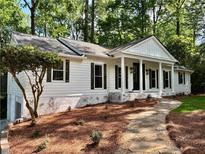 Charming one-story home with white siding, stone walkway, and covered front porch at 1230 Sunderland Ne Ct, Brookhaven, GA 30319