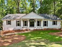 Charming one-story home with white siding, dark shutters, and a well-manicured front yard at 1230 Sunderland Ne Ct, Brookhaven, GA 30319