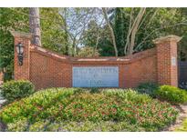Attractive brick community sign with colorful flowerbed reads, The Plantation at Lenox at 28106 Plantation Ne Dr, Atlanta, GA 30324
